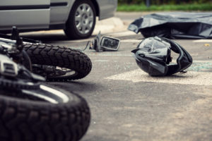 Motorcycle and helmet on the street after dangerous traffic inci